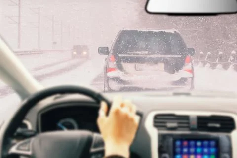 View from car inside with part of interior with driver male hand on the steer Stock Photos