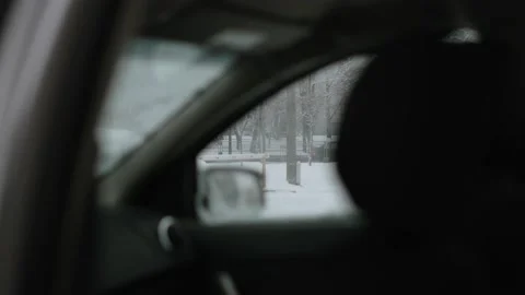 View from car interior to parking lot with barrier and city road on winter day. Stock Footage 225545342