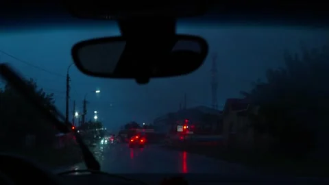 View from the car interior to the road at night, it's raining outside. Video stock 317169877