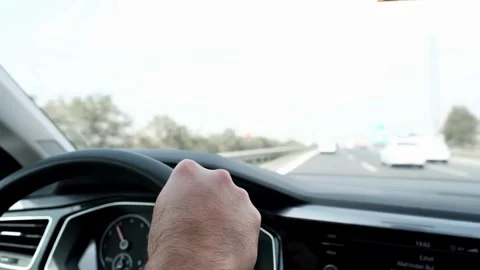 View from car interior while driving a car on highway. Hands on steering wheel Stock-Footage 336266324