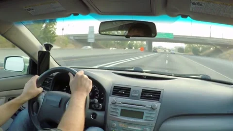 View from car interior while driving a car on highway. Hands on steering wheel Stock-Footage 336266463