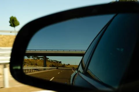 View in the car mirror on fast road in the Spain, beautiful landscape Stock Photos