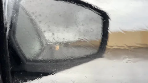 View of a car mirror from inside a car in rainy weather Stock Footage 257320867