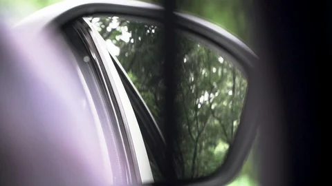 View of car mirror outside view while driving slow motion road trip travel Stock Footage 111941492
