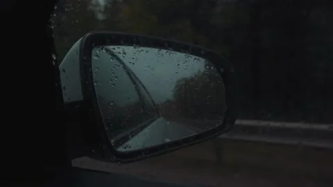 View in the car mirror sweating rain Stock Footage 233353702