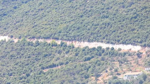 View of the car moving up by mountain road Stock Footage 172353841