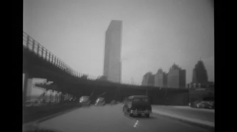 View of car moving on the road and surrounding bridge and buildings Stock Footage 37594558