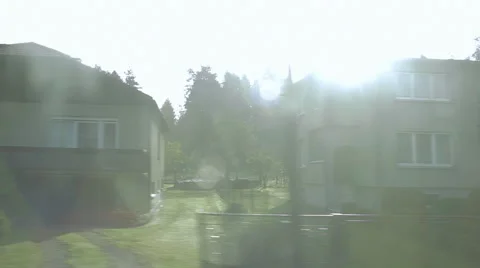 View from a car. Parallel driving along polish suburban houses.  Lens flare. Stock Footage 68027782