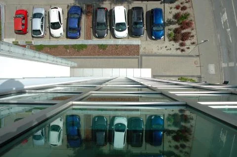 View on car parking from glass facade building Stock Photos