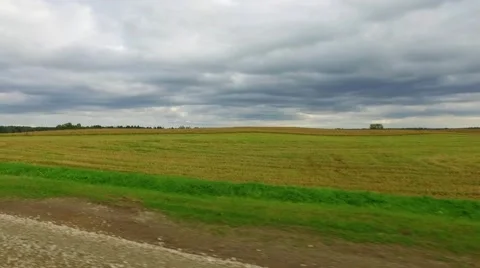 View from a car passenger window looking at the passing farmland. Stock Footage