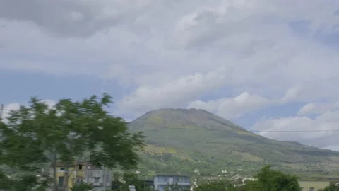 View from car passing by the volcano Vesuvius in the distance. Stock Footage 169471718