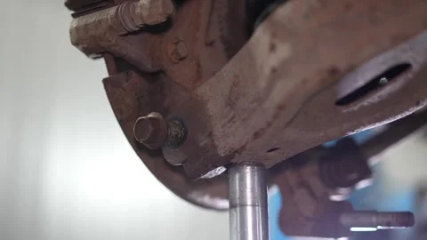 View of car rear brake disc caliper and suspension assembly on lift. Stock Footage 345912486
