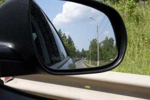 View from the car on the road with reflection in the side mirror Stock Photos