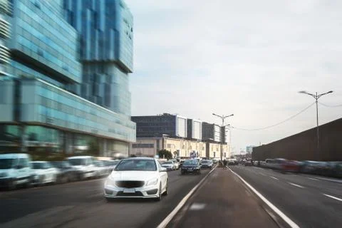 View of a car rolling fast and corporate buildings - Casablanca - Morocco Stock Photos