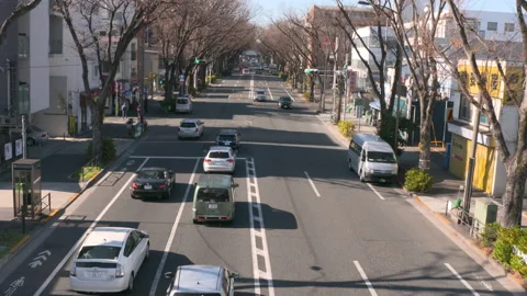 A view of a car running from the top in traffic roads of Japan Stock Footage 122227399