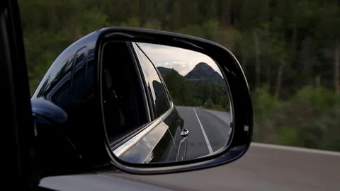 View of a car side view mirror of a mountain forest highway with a forest and Vídeo Stock 111449774