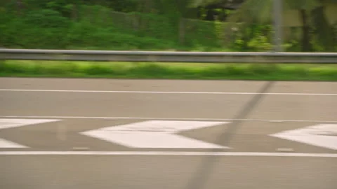 View from car side window on a fast-moving road markings pass by on asphalt Stock Footage 252833632