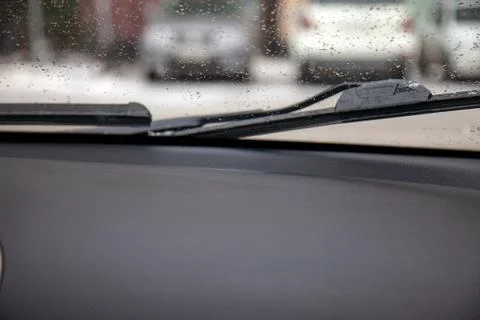 View from the car through the window to the wipers that remove the melted sno Stock Photos