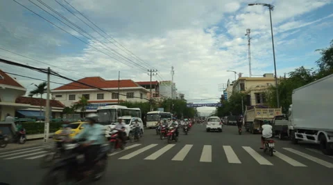 View from a car which moves on the road to central street of tourist city in Stock Footage 67814243
