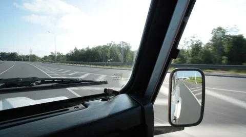 View from the car window and throgugh the mirror to the runing road Stock-Footage 62844666