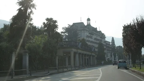 View from car window como italy palm trees and hotels Stock Footage 95248435