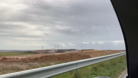 View From A Car Window On A Cornwall Motorway. Windmills. Construction Site. 動画素材 221103484