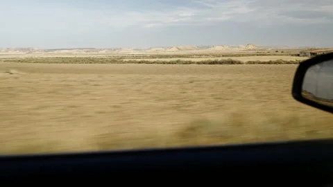 View from a car window of a desert area with mountains in the background Stock Footage 221438104