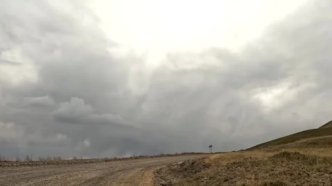 The view from the car window of a dirt road going up into the sky Stock-Footage 241381624