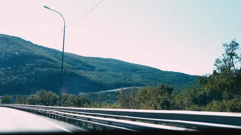 View from the car window, driving along road among the mountains. Autobahn Stock Footage 219379234