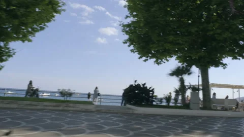 View from car window driving by the beach promenade Stock Footage 169473912