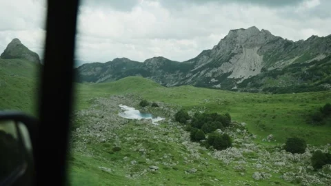 View from car window during a drive through narrow winding mountain roads Stock Footage 284390293