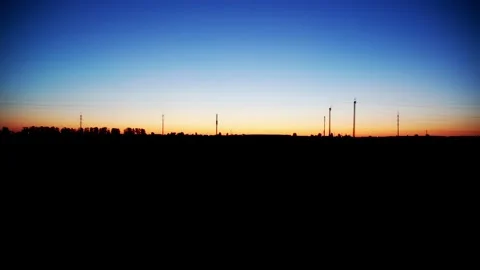 View from the car window in motion on the evening nature, orange sunset and blue Stock Footage 311648411