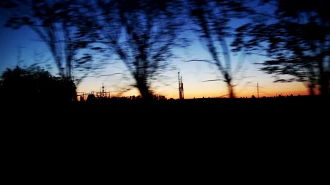 View from the car window in motion on the evening nature, orange sunset and blue Stock-Footage 312596388