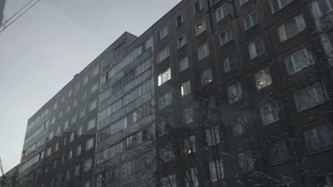 View from the car window on multi-storey buildings and snow-covered trees Stock-Footage 155727740