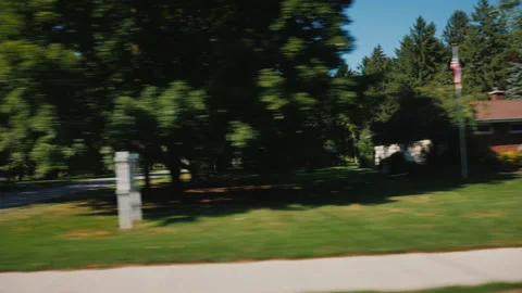 View from the car window, rides along typical houses in a small US town Stock Footage 147587236