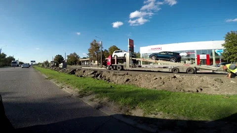 View from the car window on the road, workers in uniform repair the street. Stock Footage 160909391