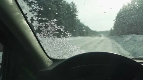 View from the car window on the snow-covered road Stock Footage 278257405