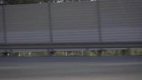 A view from a car window on a summer asphalt suburban highway. Footage. Modern Stockbeeldmateriaal 147031590