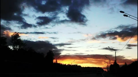 The view from the car window, the sunset, the blue, yellow sky, the lights and Stock Footage 212702048