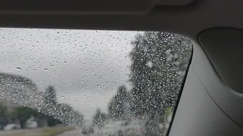 View from a car window with water drops during a rainy day drive. Stock Footage 317435045