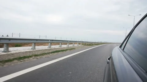 View from the car window while driving on the track with a metal catcher Stock Footage 132173535