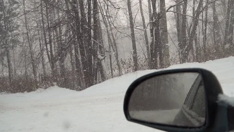 View from the car. From the window you can see how heavy it is snowing down the  Stock Footage 100010420