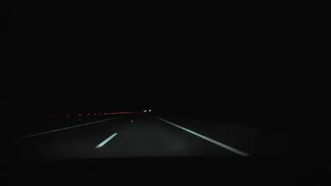 View from car windscreen window on country road at night out of city. Windshield Stock Footage 131016791