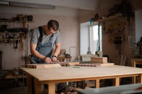 View of the carpentry shop in which a man works Stock Photos