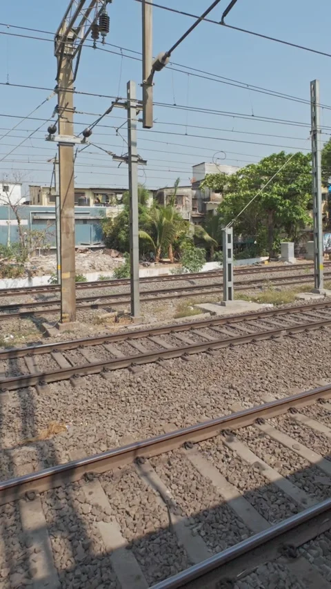 A view from the carriage of a passing train onto railway tracks in Mumbai, India Stock Footage 337323201