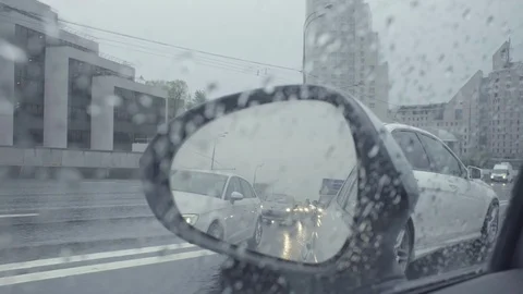 View in car's rearview mirror on the city street. Stock Footage