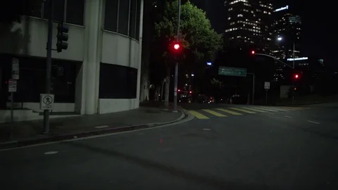 View from car's side window as it drives through city at night Stock Footage 83058636