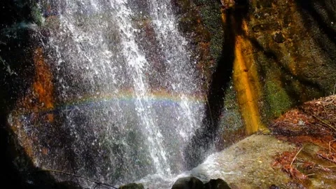View of cascade stream with rainbow reflection of light Stock Footage 239940082