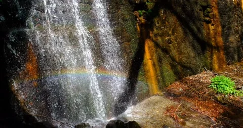 View of cascade stream with rainbow reflection of light Stock Footage 239940083