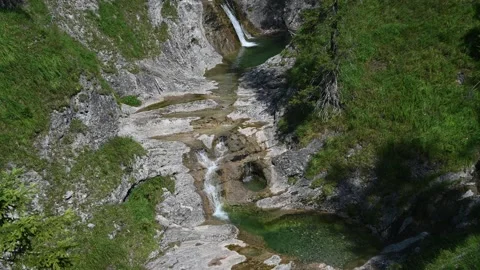 A view of cascading waterfalls and a mountain stream in a valley Stock-Footage 219633682